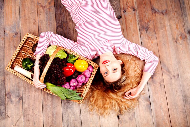 Girl carrying a basket of vegetables